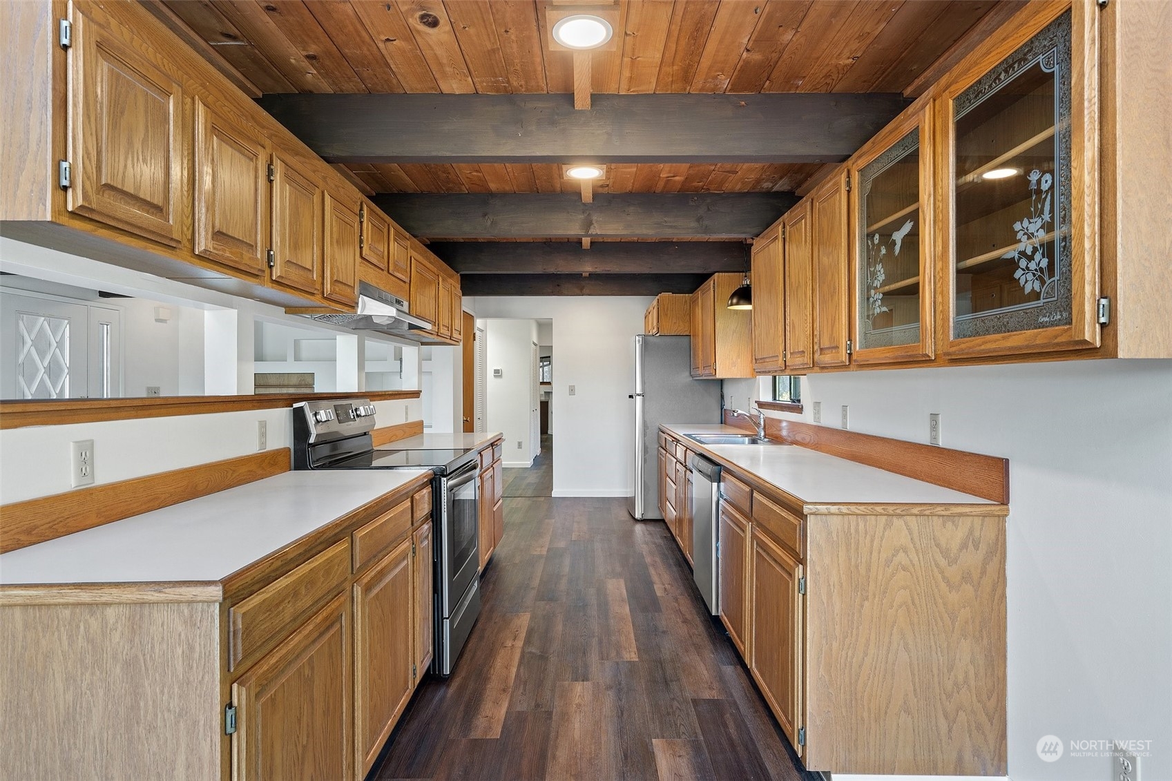 240 East Canyon View Road Belfair, WA 98528 - Photo 13 of 38 a kitchen with a sink and wooden cabinets