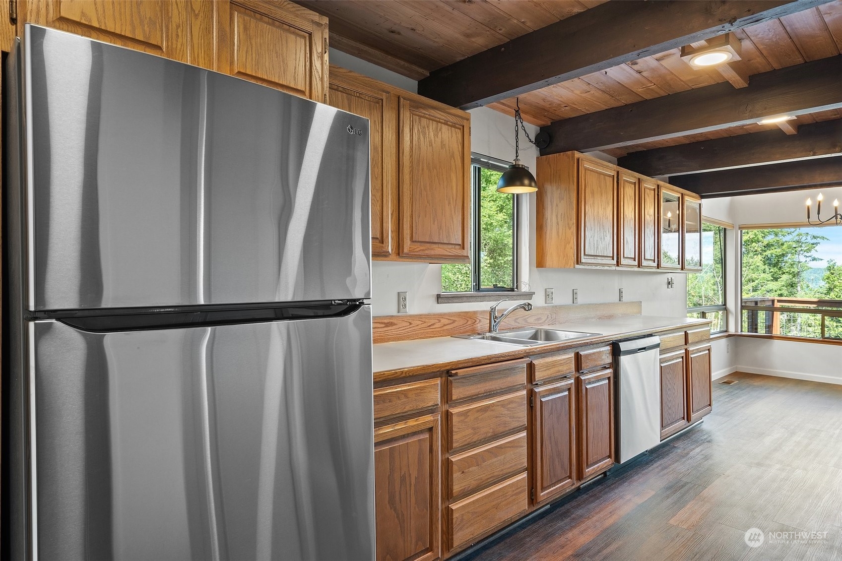 240 East Canyon View Road Belfair, WA 98528 - Photo 14 of 38 a kitchen with a refrigerator a sink and cabinets