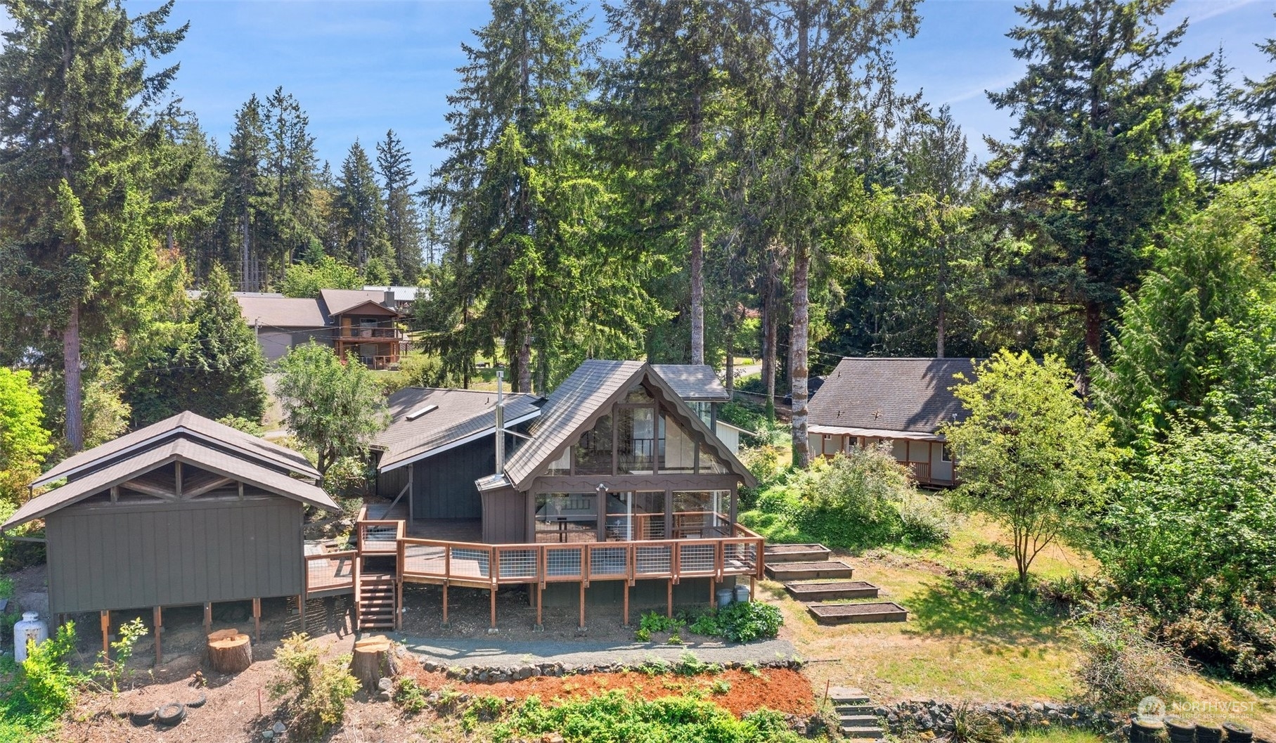 240 East Canyon View Road Belfair, WA 98528 - Photo 2 of 38 a view of a house with yard and sitting area