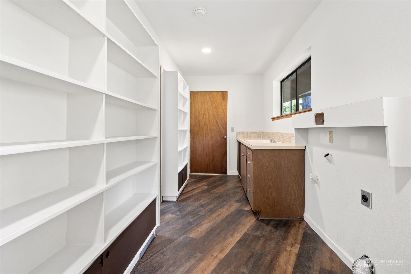 240 East Canyon View Road Belfair, WA 98528 - Photo 24 of 38 a room with a cabinets and wooden floor