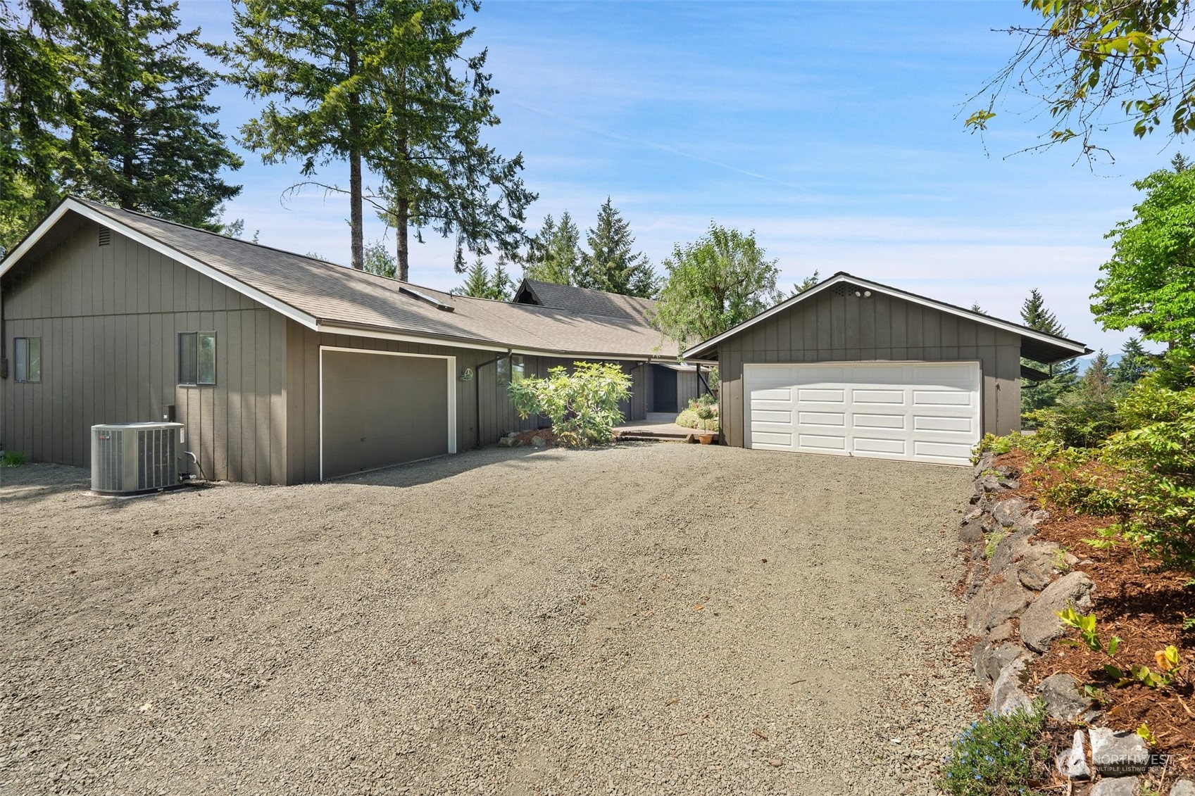 240 East Canyon View Road Belfair, WA 98528 - Photo 32 of 38 a front view of a house with a yard and garage