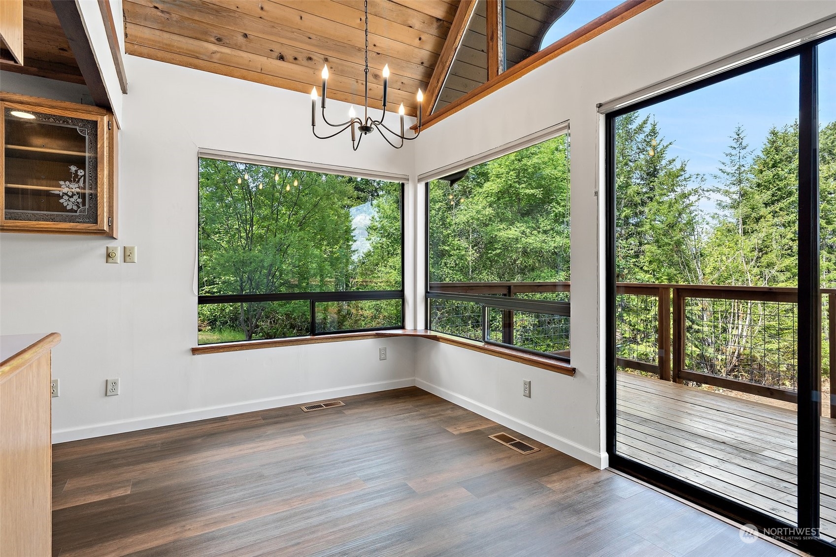 240 East Canyon View Road Belfair, WA 98528 - Photo 10 of 38 a view of an empty room with wooden floor and a window