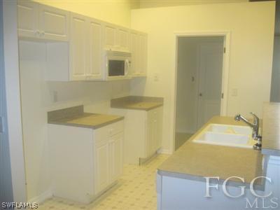 1541 Meadow Road Lehigh Acres, FL 33976 - Photo 2 of 3 a bathroom with a sink and a mirror