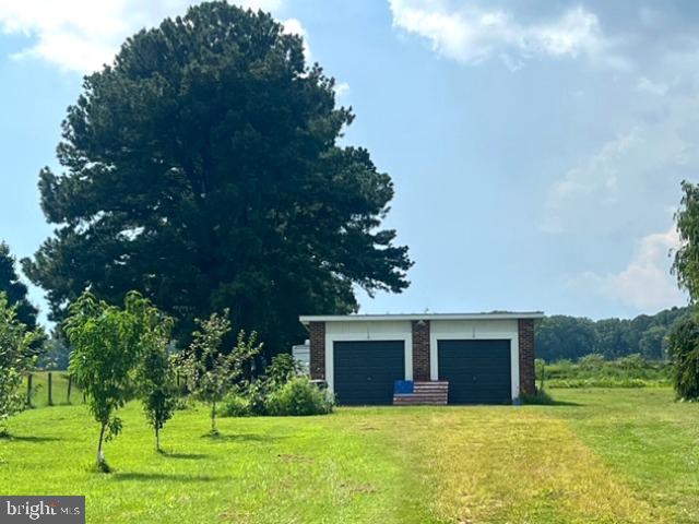 7224 Rock Hall Road Rock Hall, MD 21661 - Photo 6 of 12 a front view of house with yard and trees