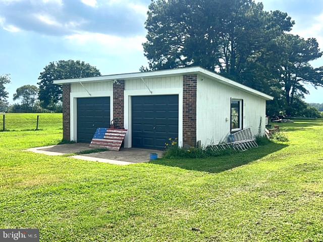 7224 Rock Hall Road Rock Hall, MD 21661 - Photo 7 of 12 a view of a house with a yard and a large tree