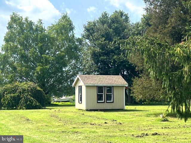 7224 Rock Hall Road Rock Hall, MD 21661 - Photo 8 of 12 a view of a house with a yard