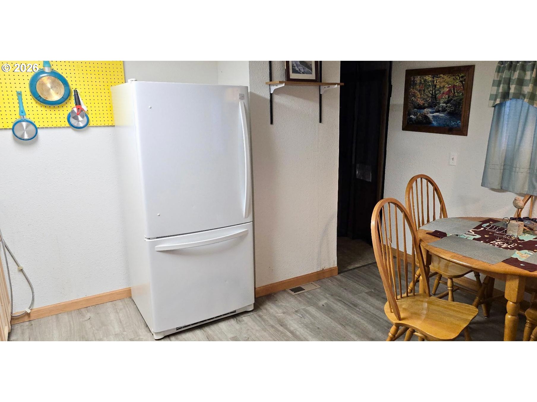 125 North 4th Street Lakeside, OR 97449 - Photo 16 of 38 a kitchen with a table and a refrigerator