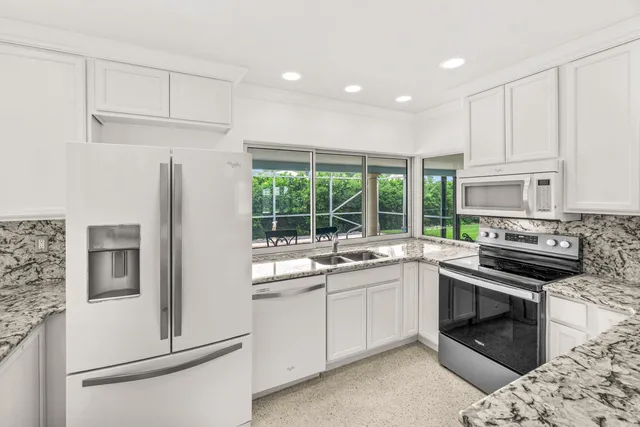 a kitchen with a sink stove and refrigerator
