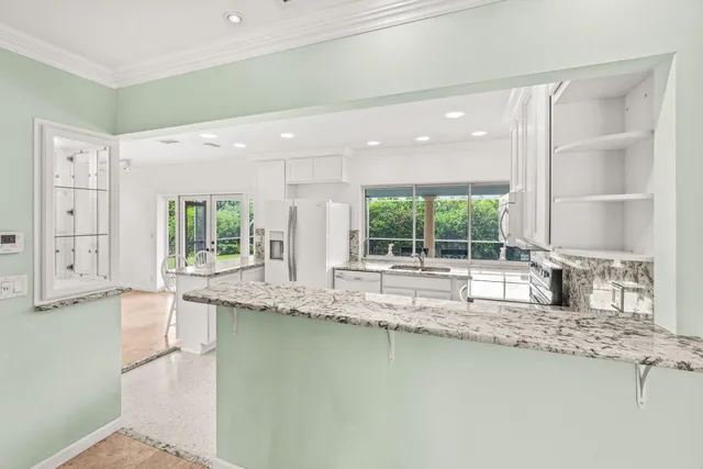 a kitchen with a window sink and cabinets
