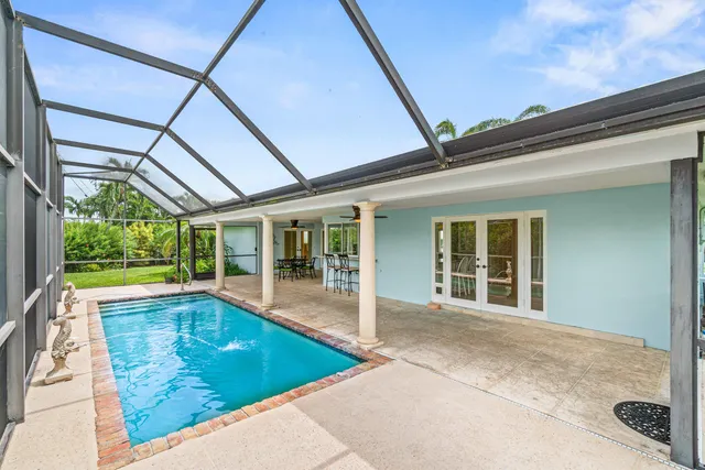 a view of a patio with swimming pool table and chairs