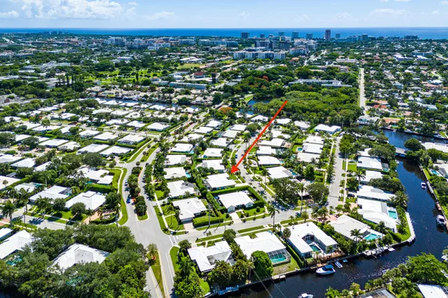an aerial view of residential houses with outdoor space and trees