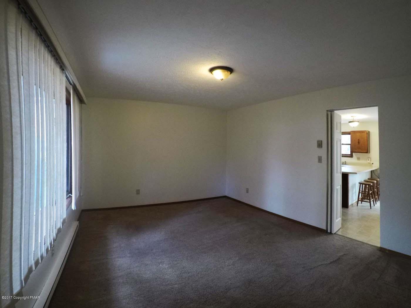 50 Dancing Ridge Road East Stroudsburg, PA 18302 - Photo 7 of 25 an empty room with wooden floor and windows