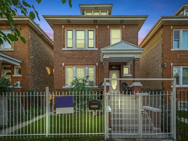 a front view of a house with plants