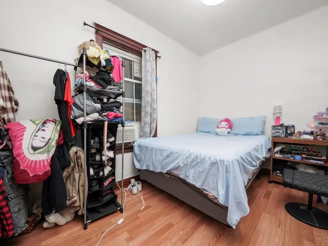 a bedroom with bed and a chandelier