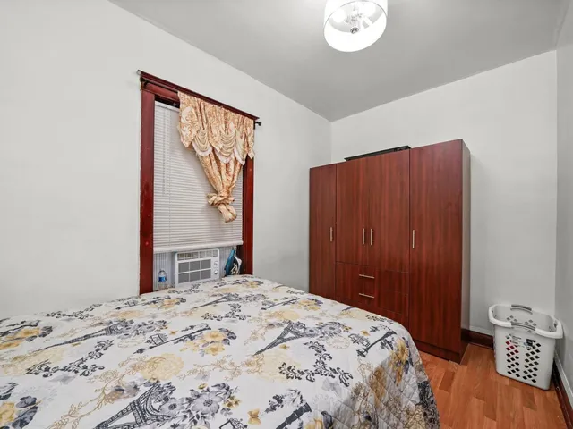 a bedroom with a large bed and a window