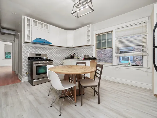 a dining room with furniture and wooden floor
