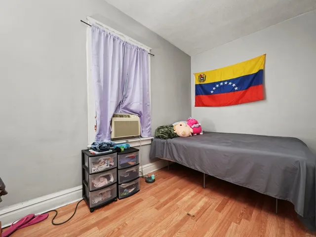 a bedroom with furniture and a wooden floor