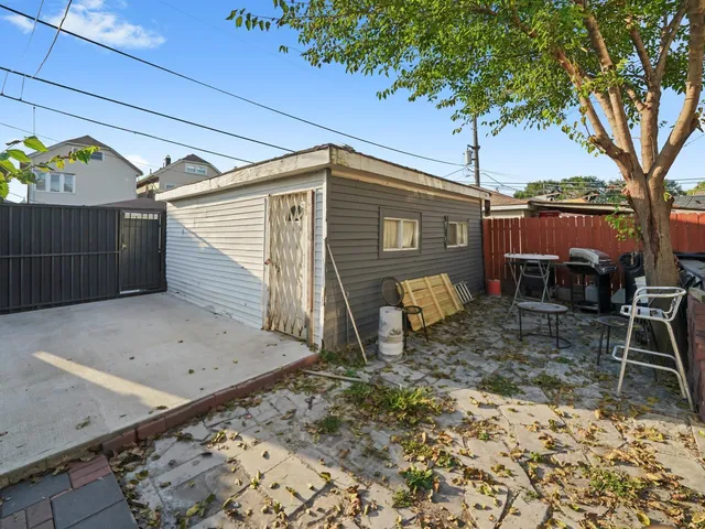 a backyard of a house with table and chairs