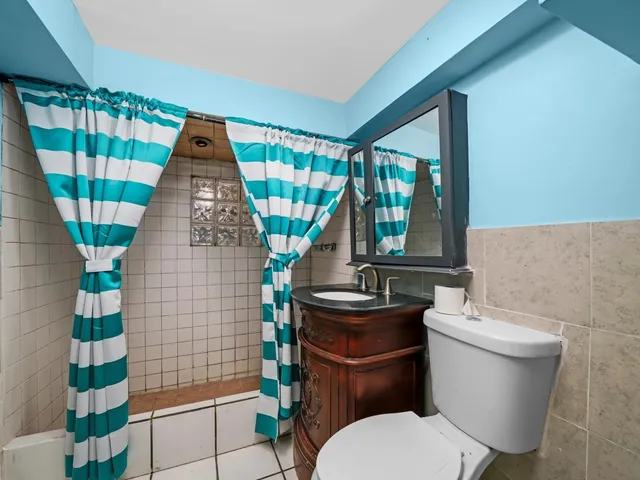 a bathroom with a toilet and a shower