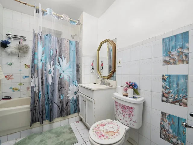a bathroom with a sink mirror toilet and bathtub