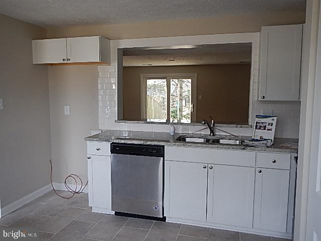 10149 Shelldrake Circle Damascus, MD 20872 - Photo 15 of 28 a kitchen with white cabinets and sink