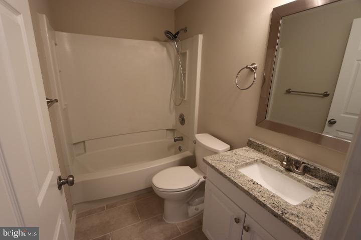 10149 Shelldrake Circle Damascus, MD 20872 - Photo 20 of 28 a bathroom with a granite countertop toilet sink and mirror
