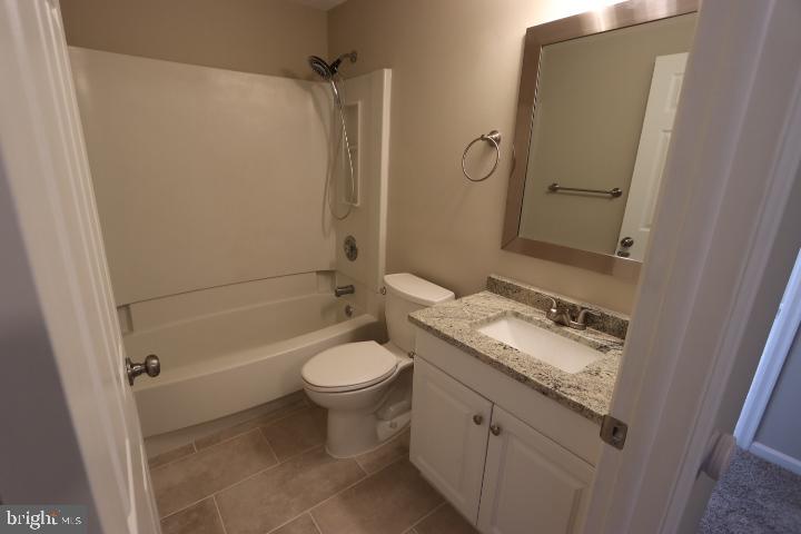 10149 Shelldrake Circle Damascus, MD 20872 - Photo 21 of 28 a bathroom with a granite countertop sink toilet and shower