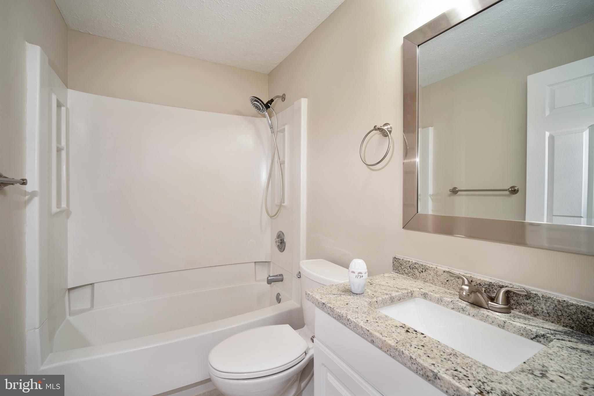 10149 Shelldrake Circle Damascus, MD 20872 - Photo 22 of 28 a bathroom with a granite countertop bathtub shower sink vanity mirror and toilet