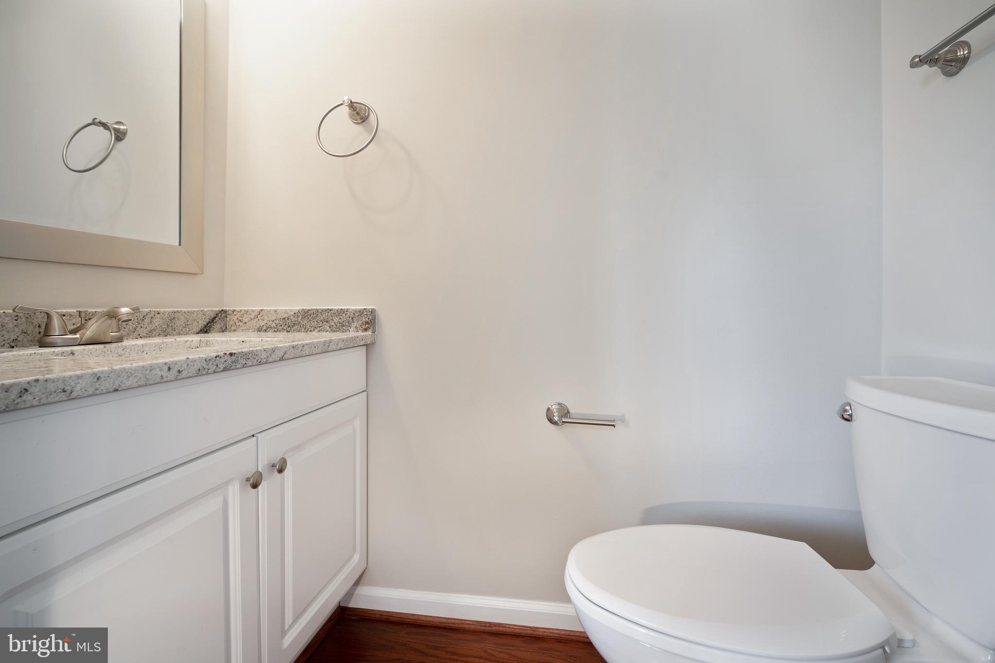 10149 Shelldrake Circle Damascus, MD 20872 - Photo 8 of 28 a bathroom with a granite countertop toilet sink and mirror