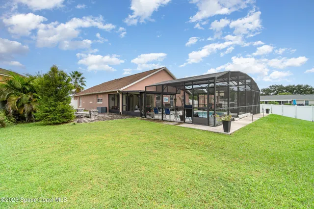 a front view of a house with yard and green space