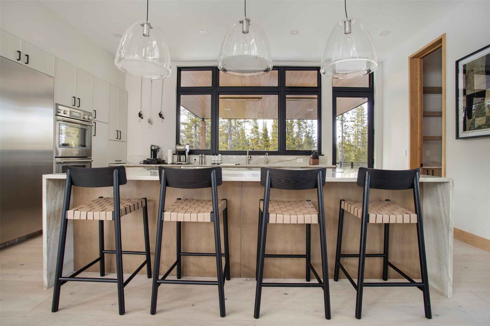 3764 Ski Hill Road Breckenridge, CO 80424 - Photo 2 of 30 Kitchen with hanging light fixtures, light wood-style floors, a breakfast bar, a spacious island, and stainless steel appliances