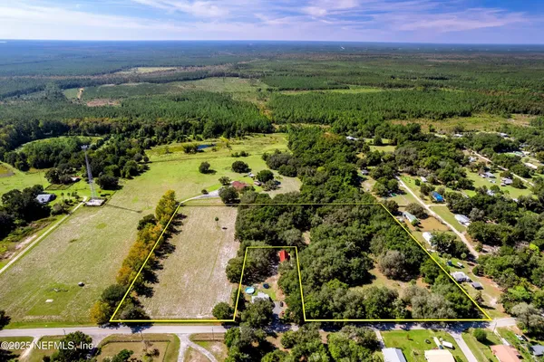 an aerial view of residential houses with outdoor space