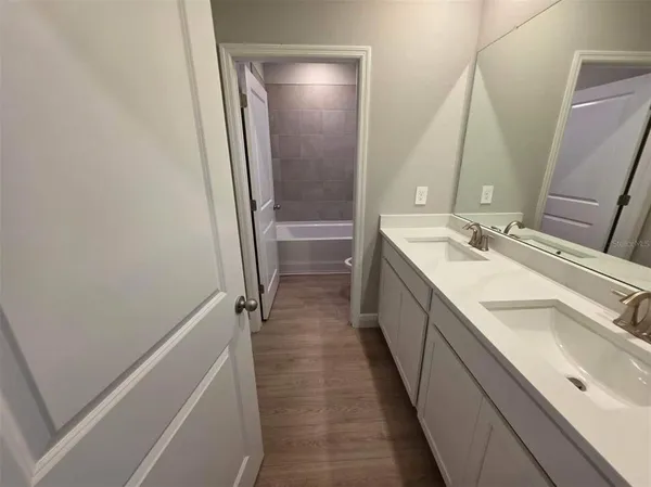 a bathroom with a double vanity sink and mirror