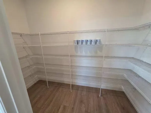 a empty closet with wooden floor