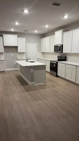 a large kitchen with a lot of counter space and appliances