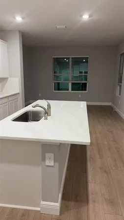 a kitchen with a sink and large window