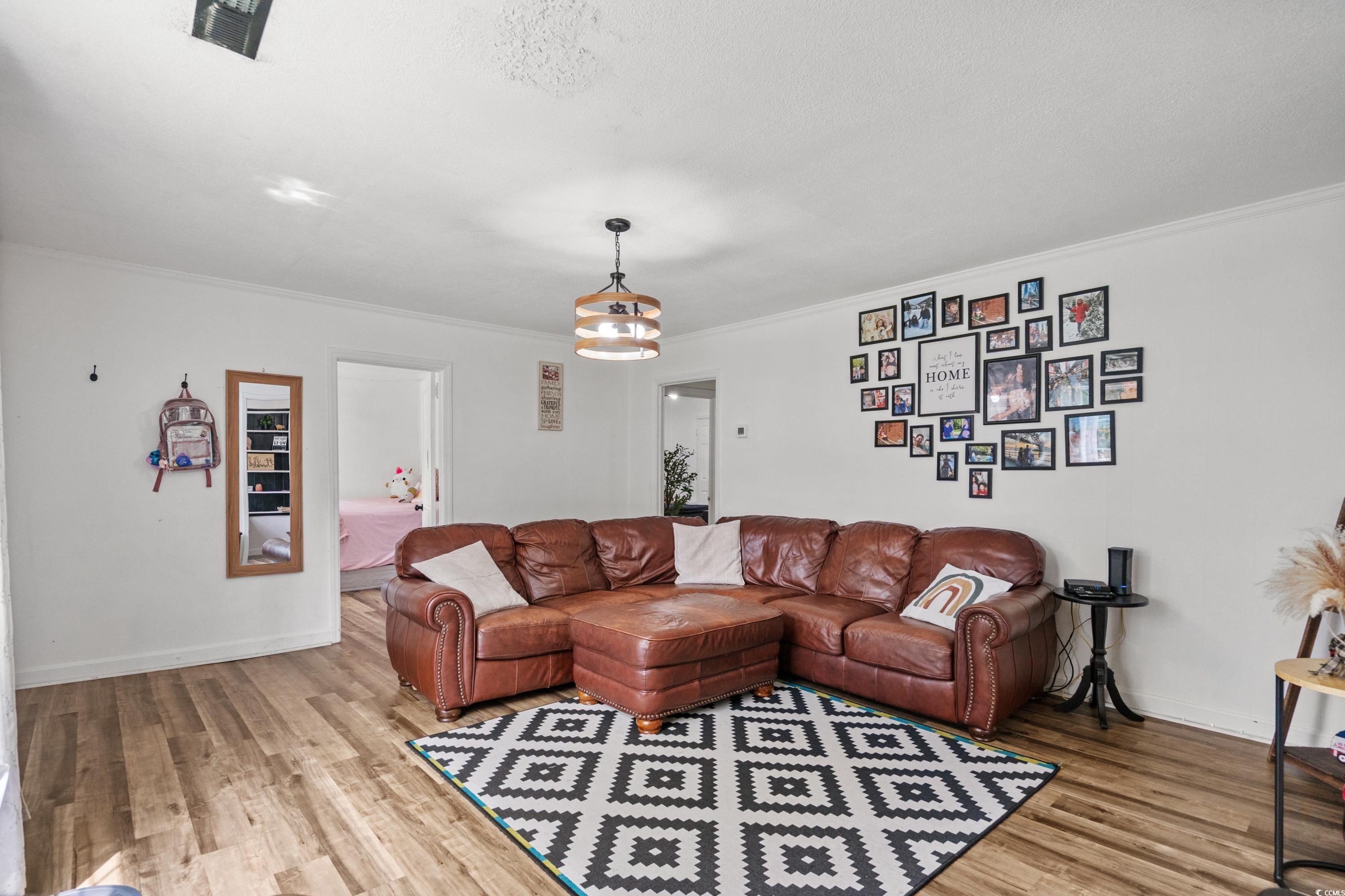 708 15th Avenue Conway, SC 29526 - Photo 2 of 38 Living area with crown molding and wood finished floors