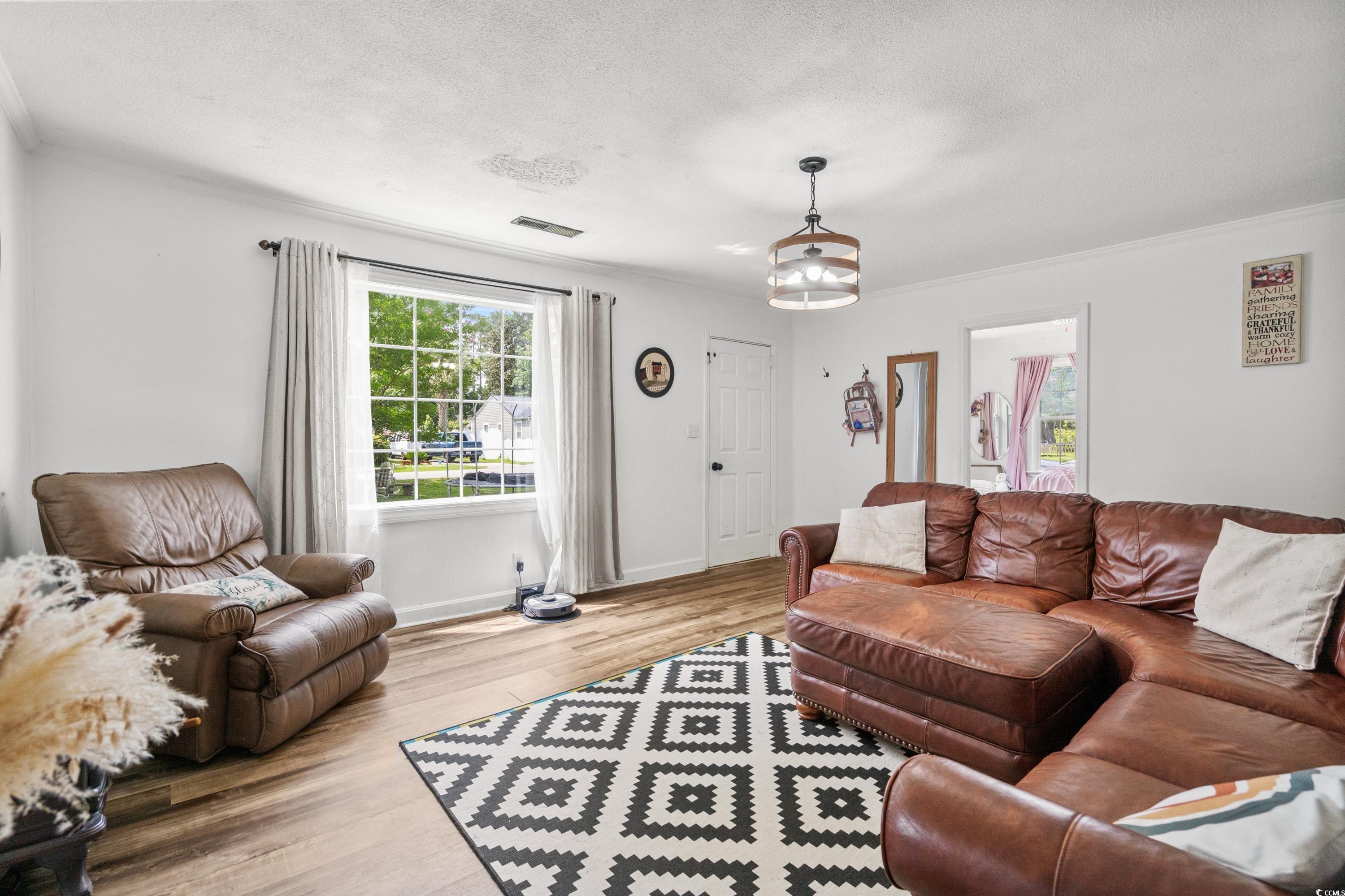 708 15th Avenue Conway, SC 29526 - Photo 3 of 38 Living room with ornamental molding and wood finished floors