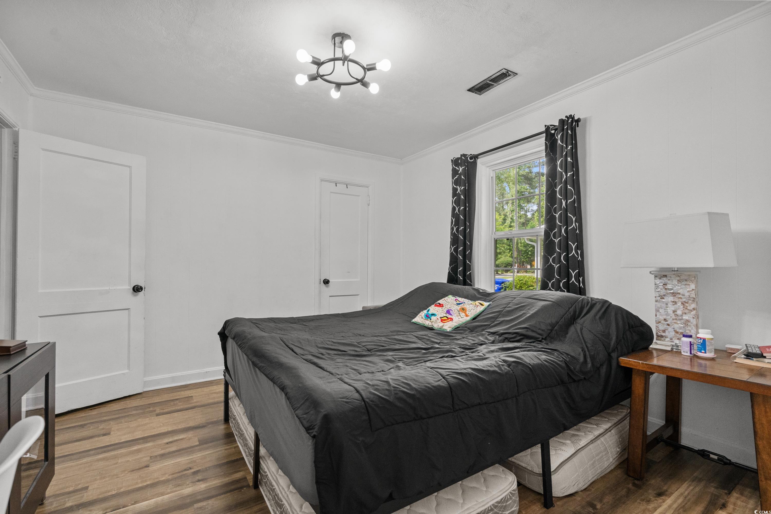 708 15th Avenue Conway, SC 29526 - Photo 6 of 38 Bedroom featuring ornamental molding, dark wood-style floors, and a chandelier