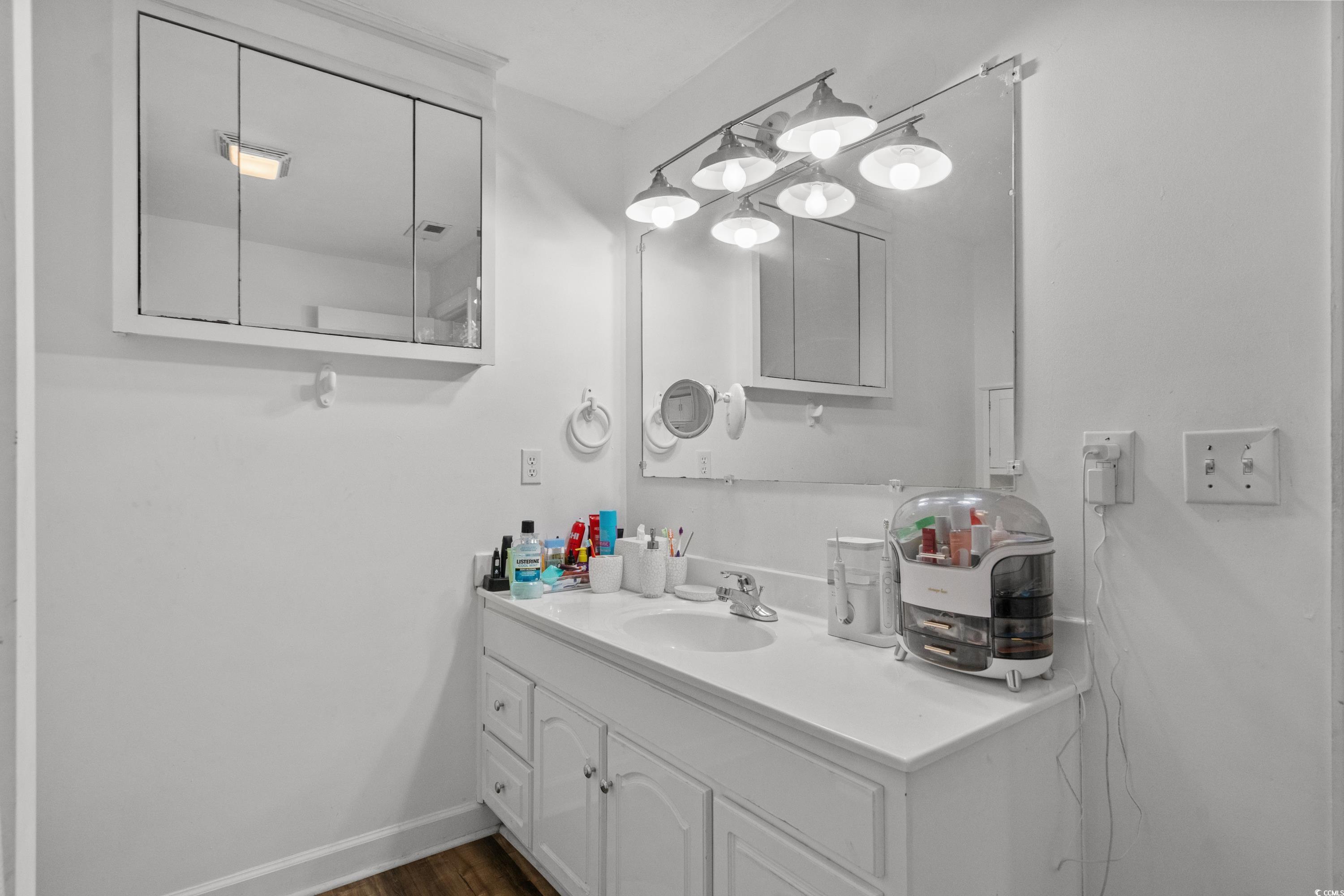 708 15th Avenue Conway, SC 29526 - Photo 8 of 38 Full bathroom with vanity, wood finished floors, and shower / bath combination with curtain