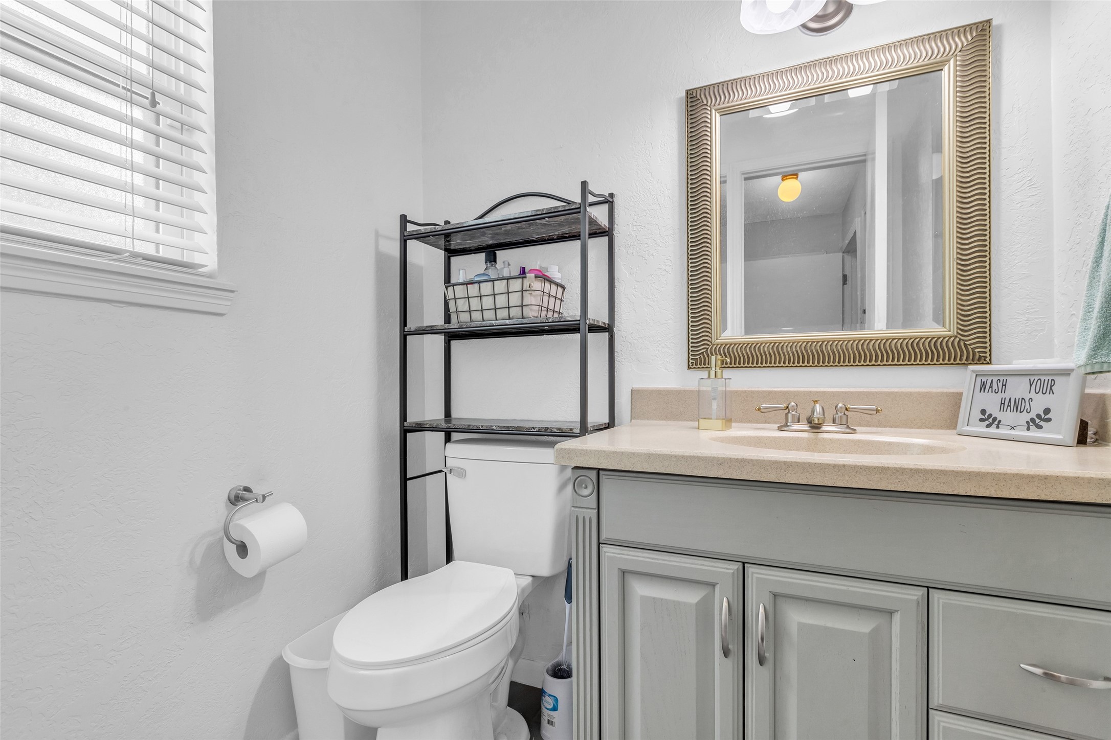 3302 Candlelon Drive Spring, TX 77388 - Photo 12 of 29 a bathroom with a toilet a sink and mirror