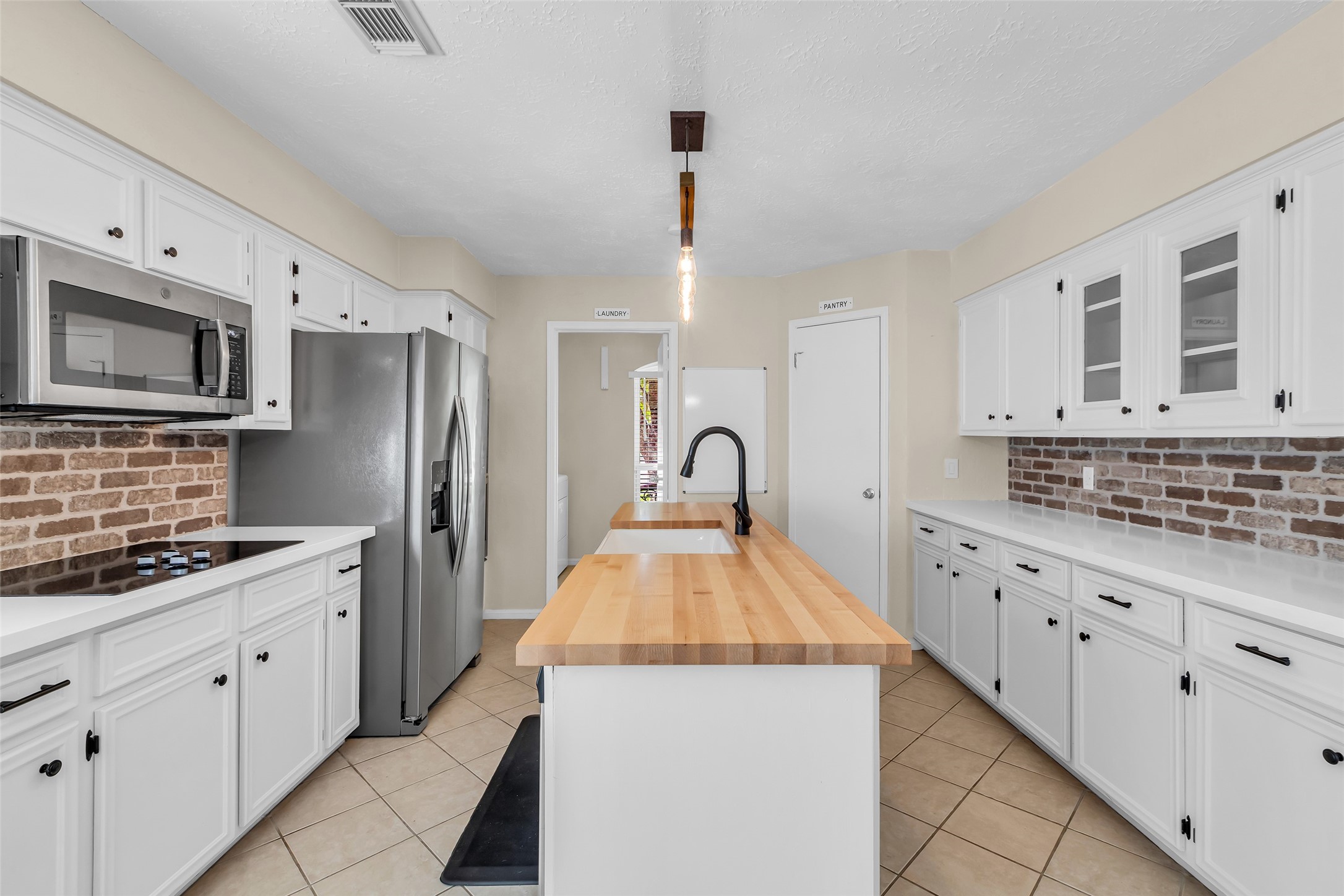 3302 Candlelon Drive Spring, TX 77388 - Photo 13 of 29 a kitchen with stainless steel appliances kitchen island granite countertop a sink stove and refrigerator