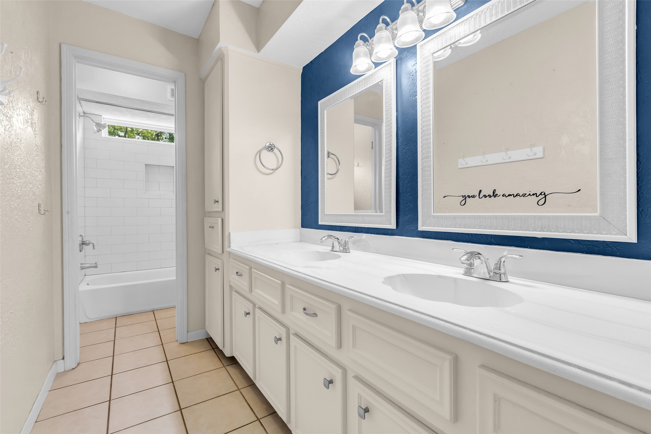 3302 Candlelon Drive Spring, TX 77388 - Photo 21 of 29 a bathroom with a double vanity sink a mirror and a bathtub