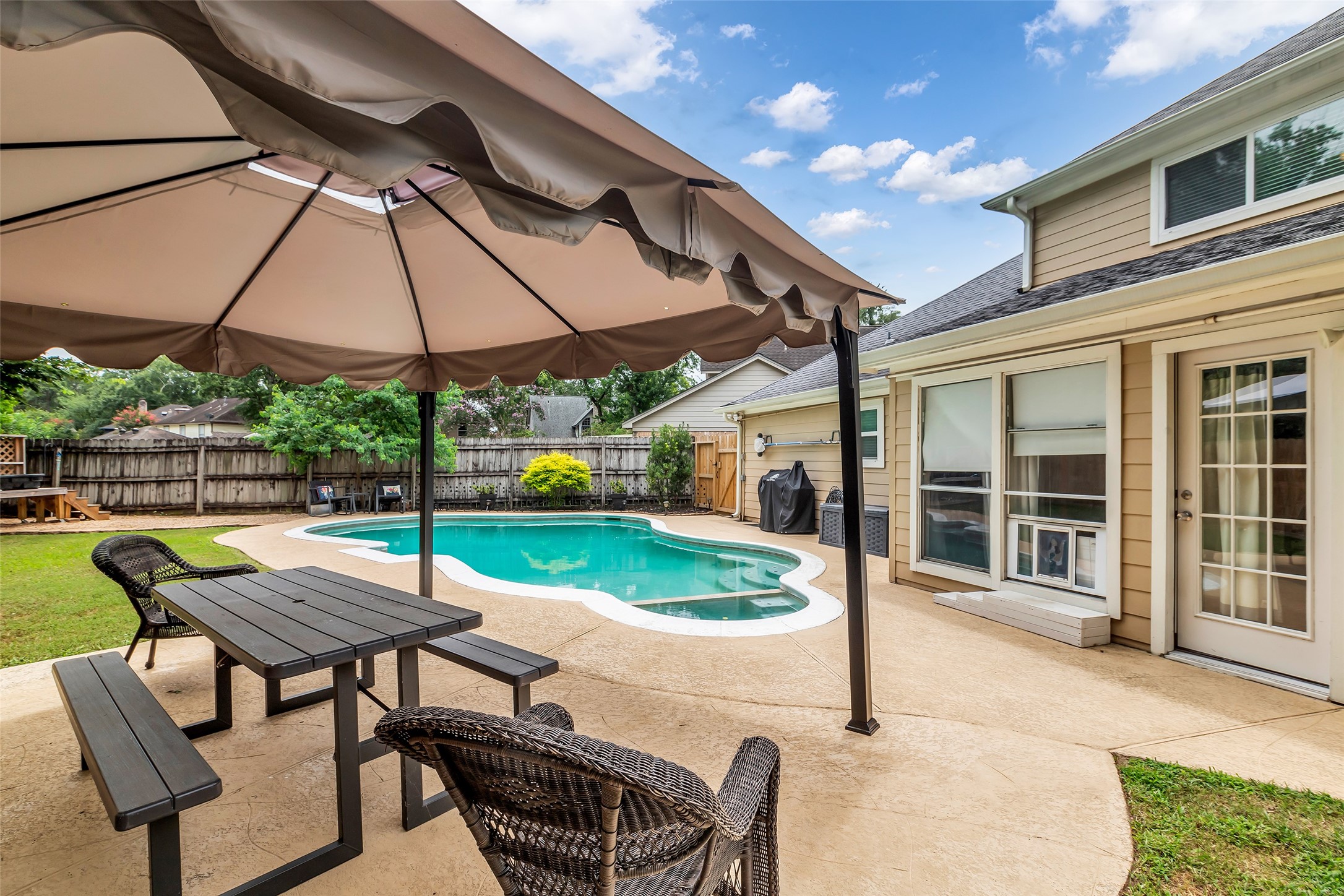 3302 Candlelon Drive Spring, TX 77388 - Photo 26 of 29 a patio with a table and chairs under an umbrella