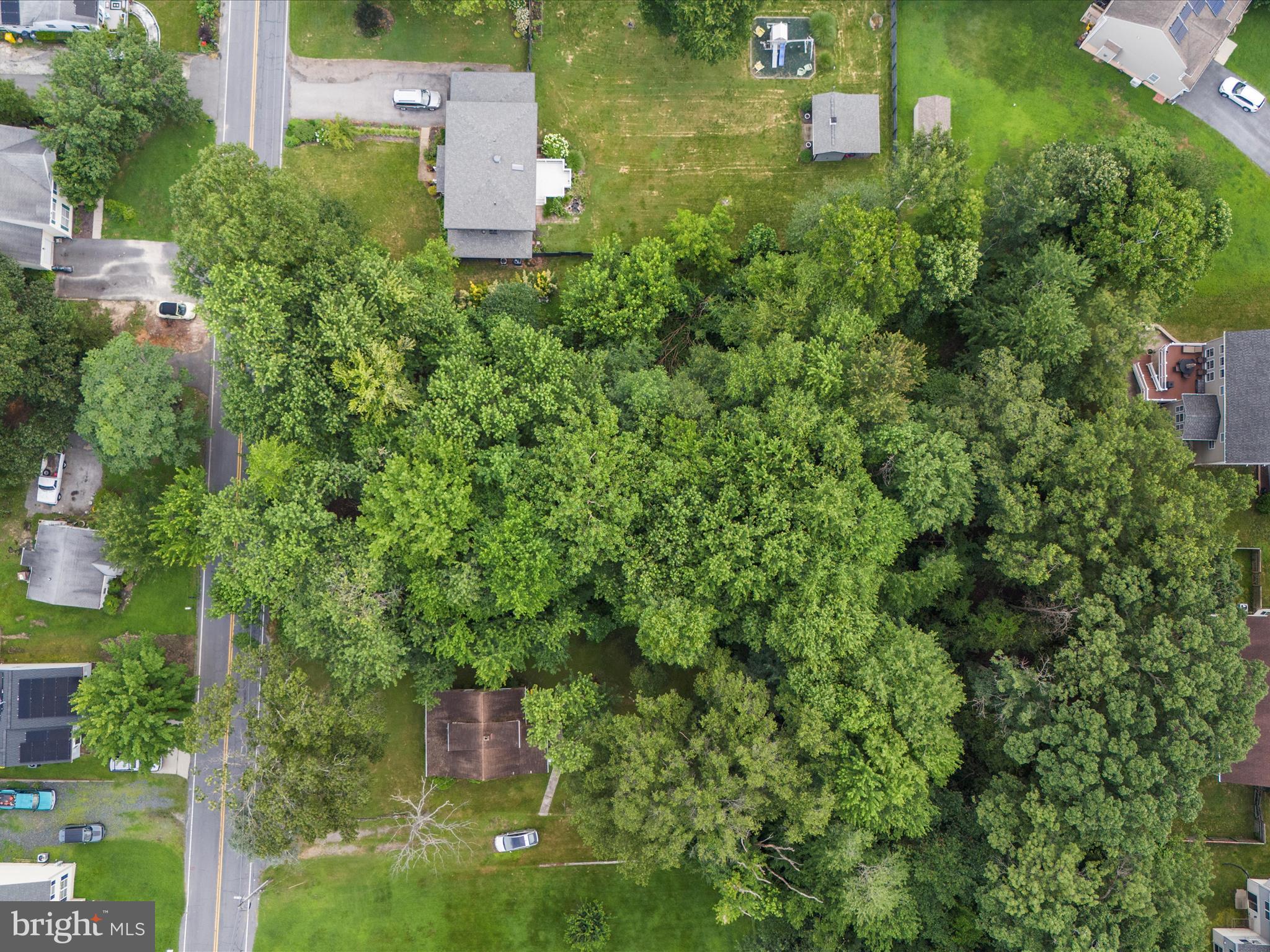 8129 Elizabeth Road Pasadena, MD 21122 - Photo 2 of 13 an aerial view of a house with a yard and trees all around