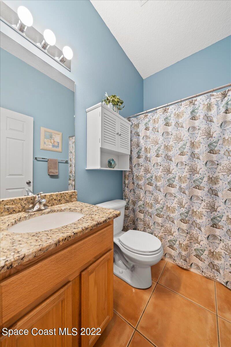 6949 Bryant Road Cocoa, FL 32927 - Photo 26 of 33 a bathroom with a sink a toilet and a mirror