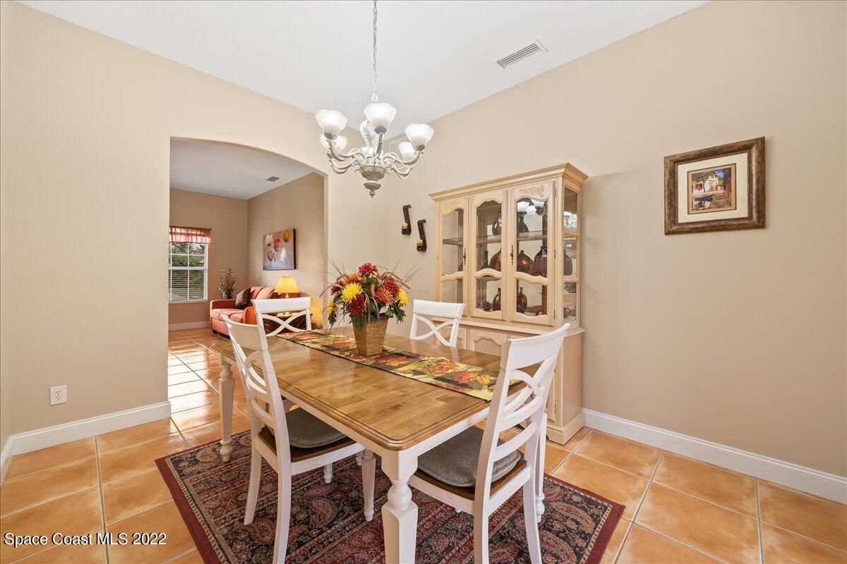 6949 Bryant Road Cocoa, FL 32927 - Photo 4 of 33 a view of a dining room with furniture and chandelier