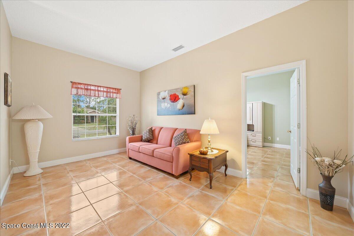 6949 Bryant Road Cocoa, FL 32927 - Photo 8 of 33 a living room with furniture and a window