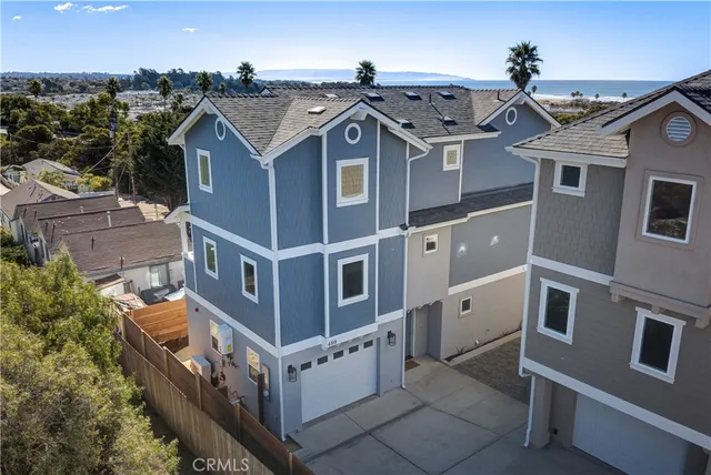 an aerial view of a house with a mountain