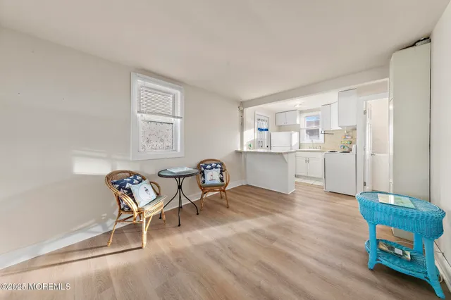 a kitchen with white cabinets and sink